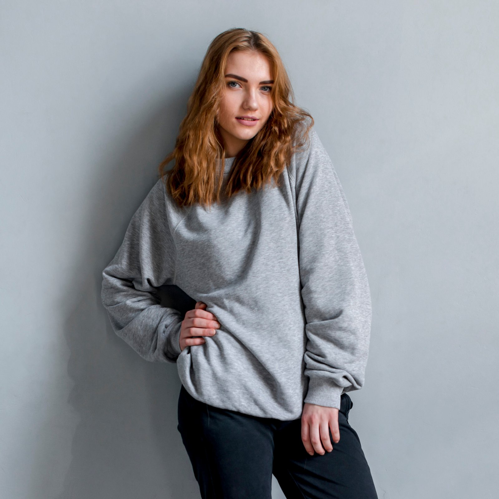 portrait-beautiful-young-woman-standing-against-grey-wall